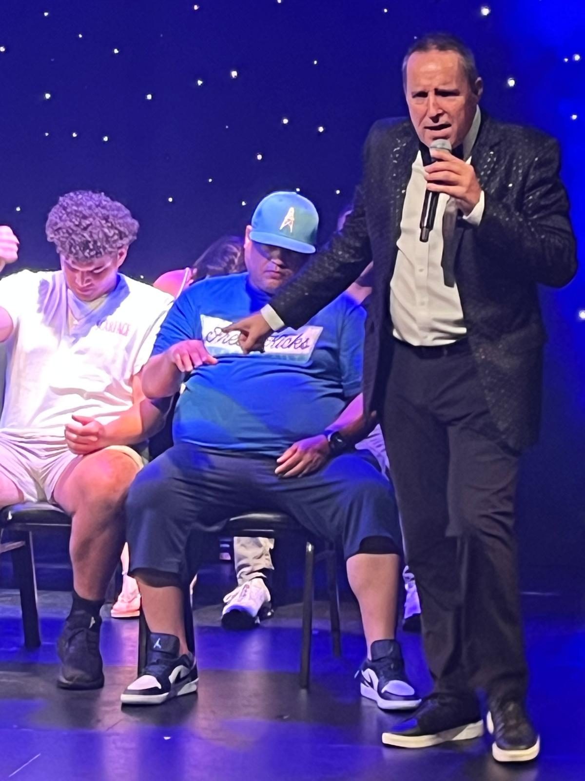 Richard Barker on stage with the microphone