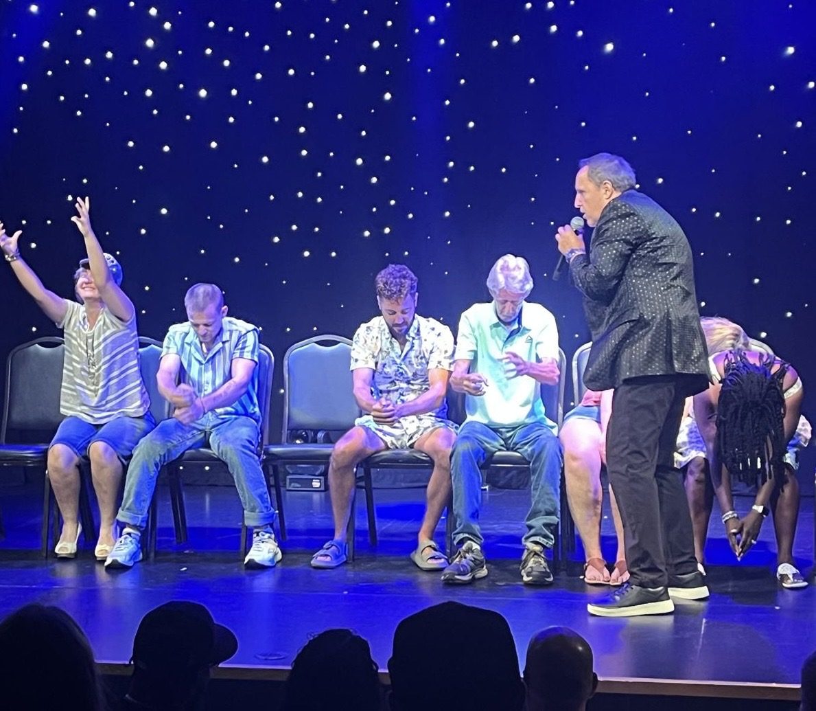 Hypnotized volunteers throwing their hands up