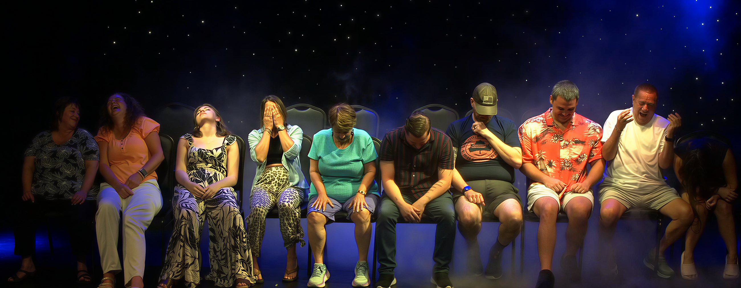 Hypnotized volunteers laughing on stage